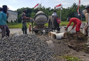 Satgas TMMD Dan Masyarakat Memindahkan Sisa Agregat Pekerjaan Pengecoran